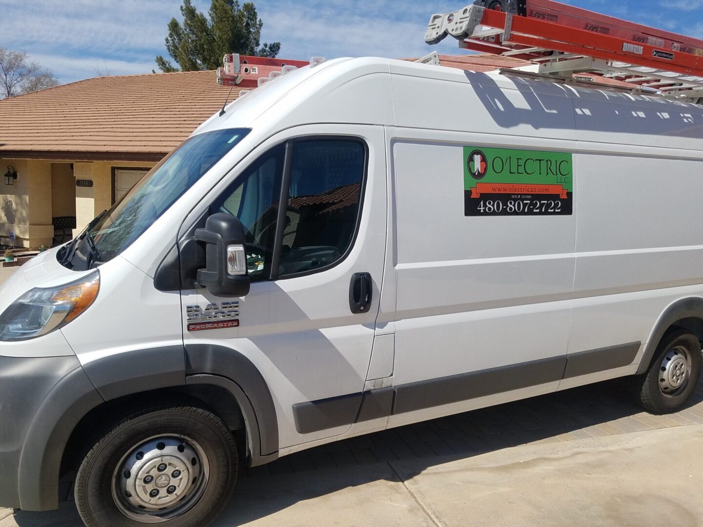 A white van with a ladder on the side of it.