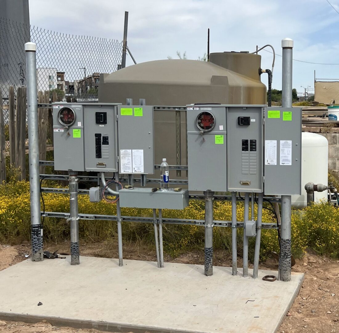 A bunch of electrical boxes on the side of a road.