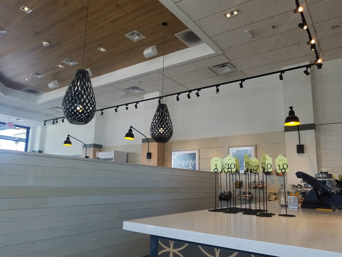 A restaurant with many lights hanging above the counter.