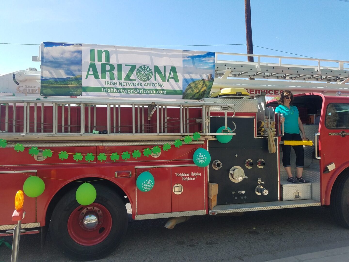 A red and black bus with people in it