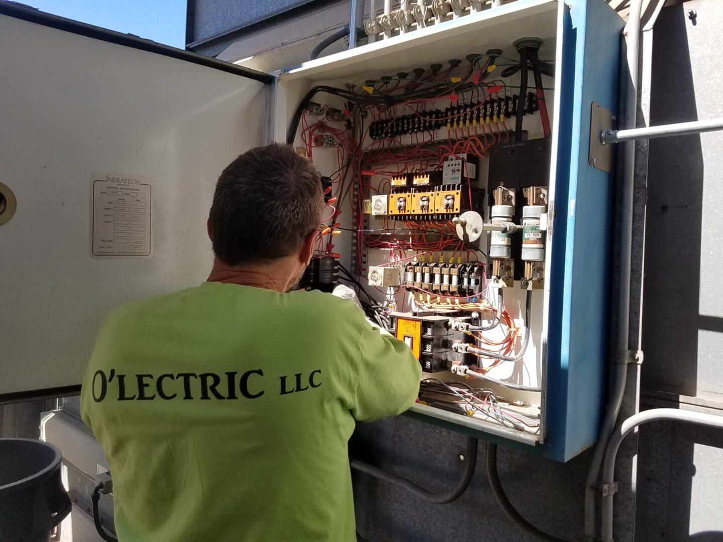 A man working on an electrical panel.