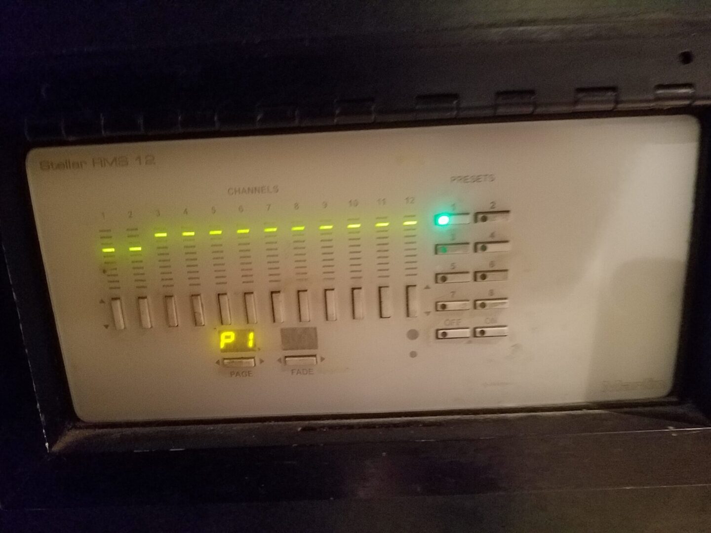 A white panel with green and yellow lights on it.